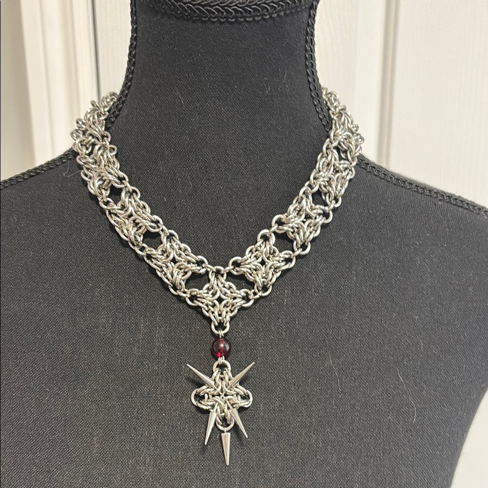 Intricate Silver and Red Necklace with V-Shaped Design